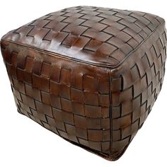 a large brown leather basket sitting on top of a white floor