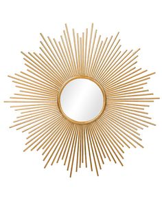 a gold sunburst mirror on a white wall