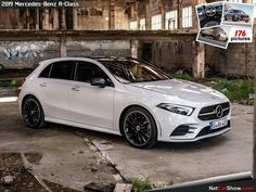 a white car parked in front of an old building with graffiti on it's walls