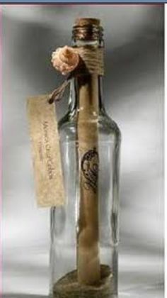 a message in a bottle with a flower on the top and a tag attached to it