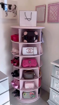 a pink shelf filled with lots of purses next to a white dresser and drawers