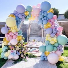 an arch made out of balloons and flowers