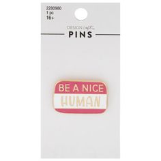 a pink and white pin with the words be a nice human on it's back