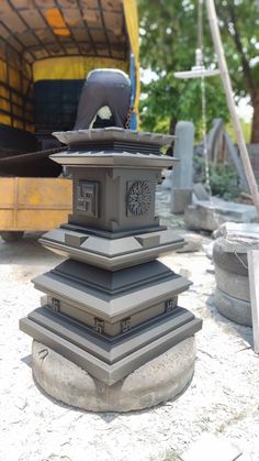 a large clock tower sitting on top of a cement block