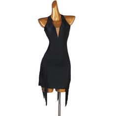 a mannequin wearing a black dress with an open back and fringes on the sides