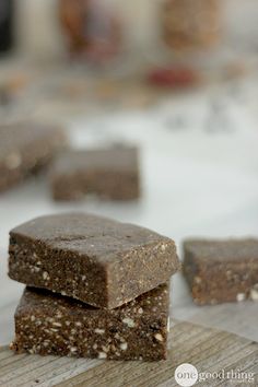 three pieces of brownie sitting on top of a wooden cutting board