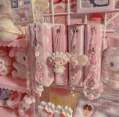 hello kitty products are on display in a toy store, with other items hanging from the shelves