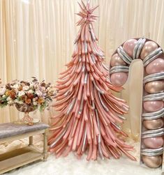 a pink christmas tree made out of balloons