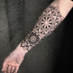 a woman's arm with a tattoo on it and a flower in the middle