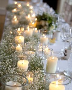 a long table with candles and flowers on it