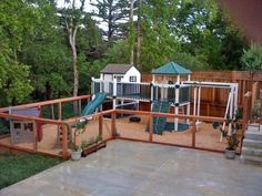 an outdoor play area in the backyard with swings, slides and playset for children