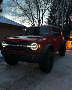 a red truck parked in front of a house