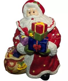 a santa clause figurine holding presents