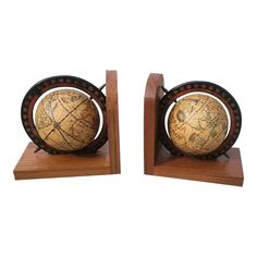 two wooden bookends with a globe on each one and a black border around the edges