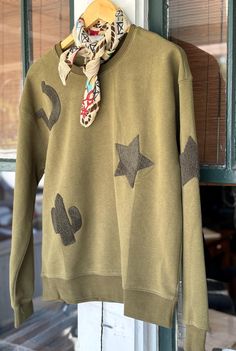 This may be the perfect sweatshirt!! Love the Olive Green Color! Screams Fall Western Style! True To Size! So soft + comfy! We will also have it available in tan soon!  Available: Small 2-4 Medium 6-8 Large 10-12 Casual Sweatshirt With Star Patch For Fall, Casual Fall Sweatshirt With Star Patch, Casual Star Print Sweatshirt For Loungewear, Relaxed Fit Star Print Sweatshirt For Fall, Relaxed Fit Sweatshirt With Star Print For Fall, Fall Cotton Sweatshirt With Star Patch, Casual Fall Tops With Star Patch, Patchwork Sweatshirt, Fort Pierce