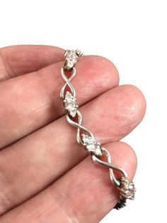 Beautiful Sterling Silver CZ link bracelet. Lovely sparkling stones prong set . Signed 925 CII China. Classic design. Measures 7" and has a slide safety clasp. Condition is very good. This is a beautiful bracelet and perfect for a special occasion.