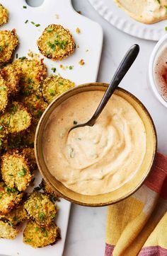 a bowl of dipping sauce next to some fried food