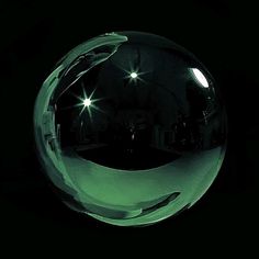 a shiny glass ball on a black background