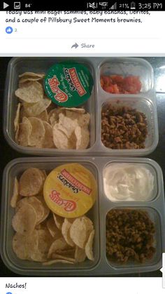 four plastic containers filled with different types of food on top of a table next to a cell phone