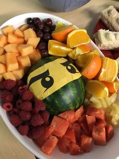 a white plate topped with fruit and veggies