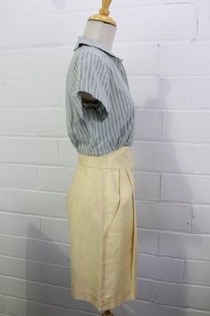 "This is a lovely pair of vintage 80s linen high waist Bermuda shorts. The longer length makes them perfect for business casual looks, and the bright cream linen is summery and fresh. Wear them with a crisp button up blouse or a simple t-shirt for a relaxed yet chic outfit. The waistband is nice and wide with a double button closure, and the legs are cuffed. COLOR: Cream MATERIAL: Linen CONDITION: Overall excellent, but there are two small yellow marks at the top of the waistband on the right si Vintage Summer Workwear Bottoms, Vintage Workwear Shorts For Summer, Vintage Cream Bottoms For Summer, Vintage Cream Summer Bottoms, Fitted Vintage Linen Bottoms, Fitted Beige Linen Shorts, Cream Knee-length Bottoms For Summer, Vintage Beige Shorts For Spring, Vintage Beige Bottoms For Summer