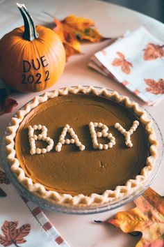 a pumpkin pie with the word baby spelled on it