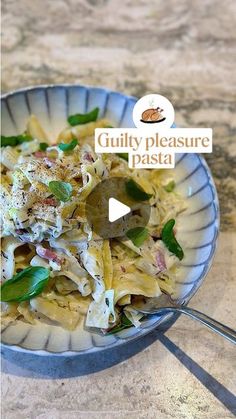 a bowl filled with pasta and vegetables on top of a table