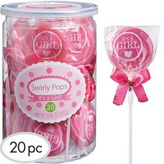 pink lollipops in a glass jar with a bow on the top and label