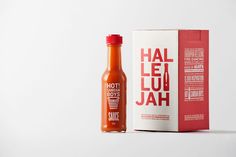 a bottle of hot sauce next to a cardboard box on a white background with red lettering