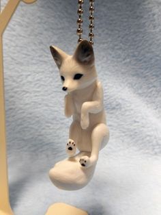 a small figurine is hanging from a chain