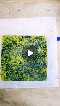 a piece of paper that has been made with green and blue inks on it