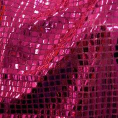 pink sequins are covering the surface of a piece of clothing that is shiny