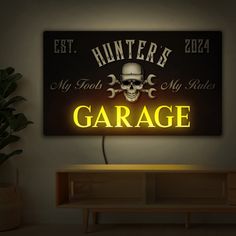 a neon sign that reads, hunter's garage with a skull and bones on it