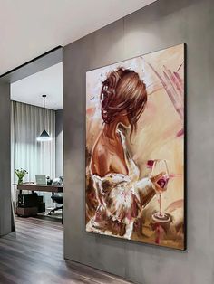 a painting hanging on the wall next to a chair and table in a living room