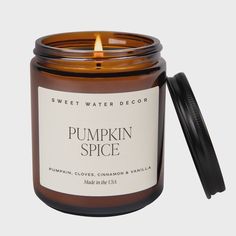 a pumpkin spice candle with a black lid