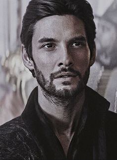 a black and white photo of a man with long hair