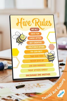 a sign that says hive rules on the front and back of it, next to some markers