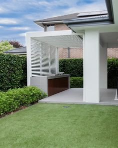 a modern house with an outdoor kitchen in the back yard