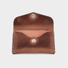 a brown leather wallet with a card holder in the front and an empty pocket on the back