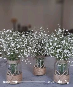 three mason jars filled with baby's breath flowers