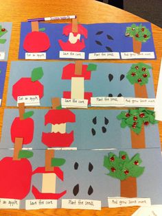 an apple tree is cut out from paper and placed on top of a wooden table