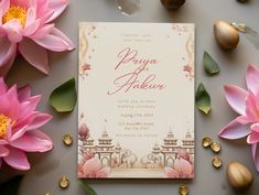 the wedding card is surrounded by pink flowers