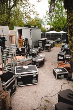 an outdoor area with many different types of equipment on the ground and trees in the background