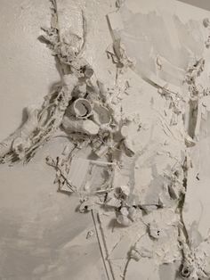 an abstract painting with white paint on the wall