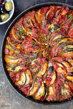 an overhead view of a baked vegetable dish in a skillet with text overlay