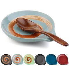 a wooden spoon sitting on top of a plate next to four different colored bowls and saucers