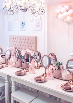 there are many mirrors on the table with pink decorations