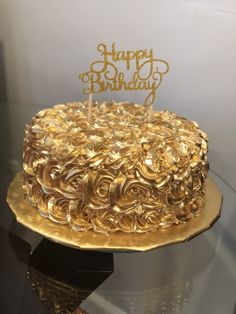 a golden birthday cake with the words happy birthday on it