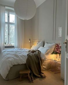 a bedroom with a large bed and white walls