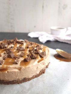 a cake sitting on top of a table covered in frosting and caramel toppings